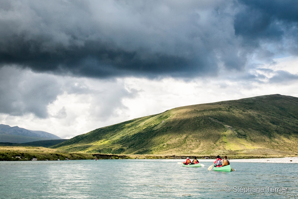 Paddlers canoeing on a remote river