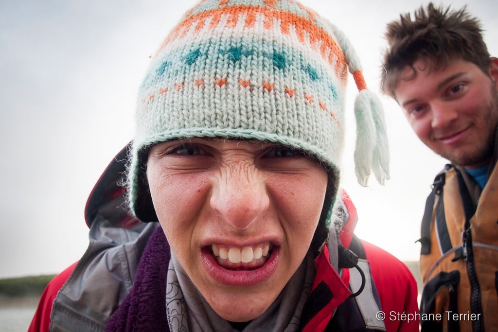 Close-up of person's face wearing a warm hat and making a funny face