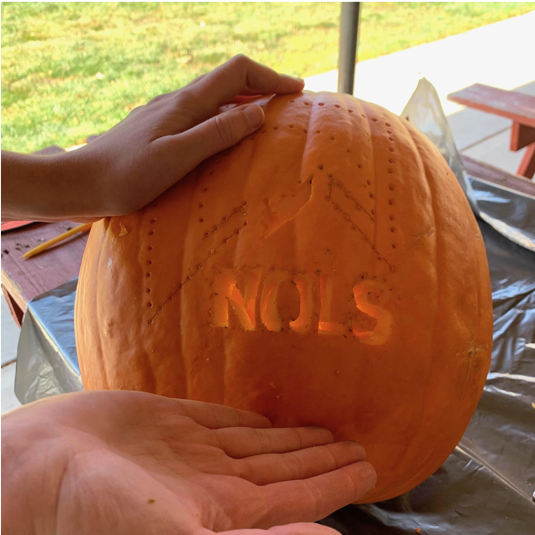 NOLS pumpkin in the process of being carved